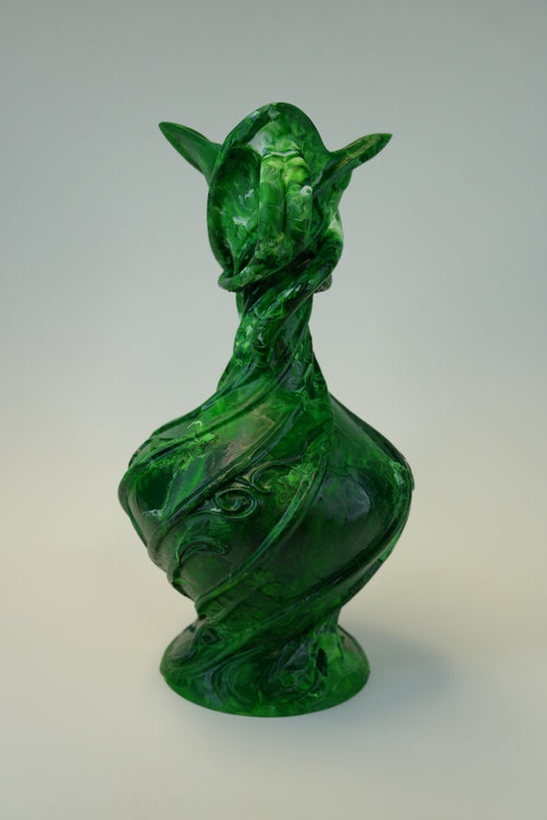 A sculptural green vase with a stylized animal or dragon-like head and curved, twisted body, photographed against a plain light gray studio background.
