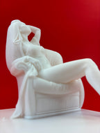 White classical sculpture against a red background