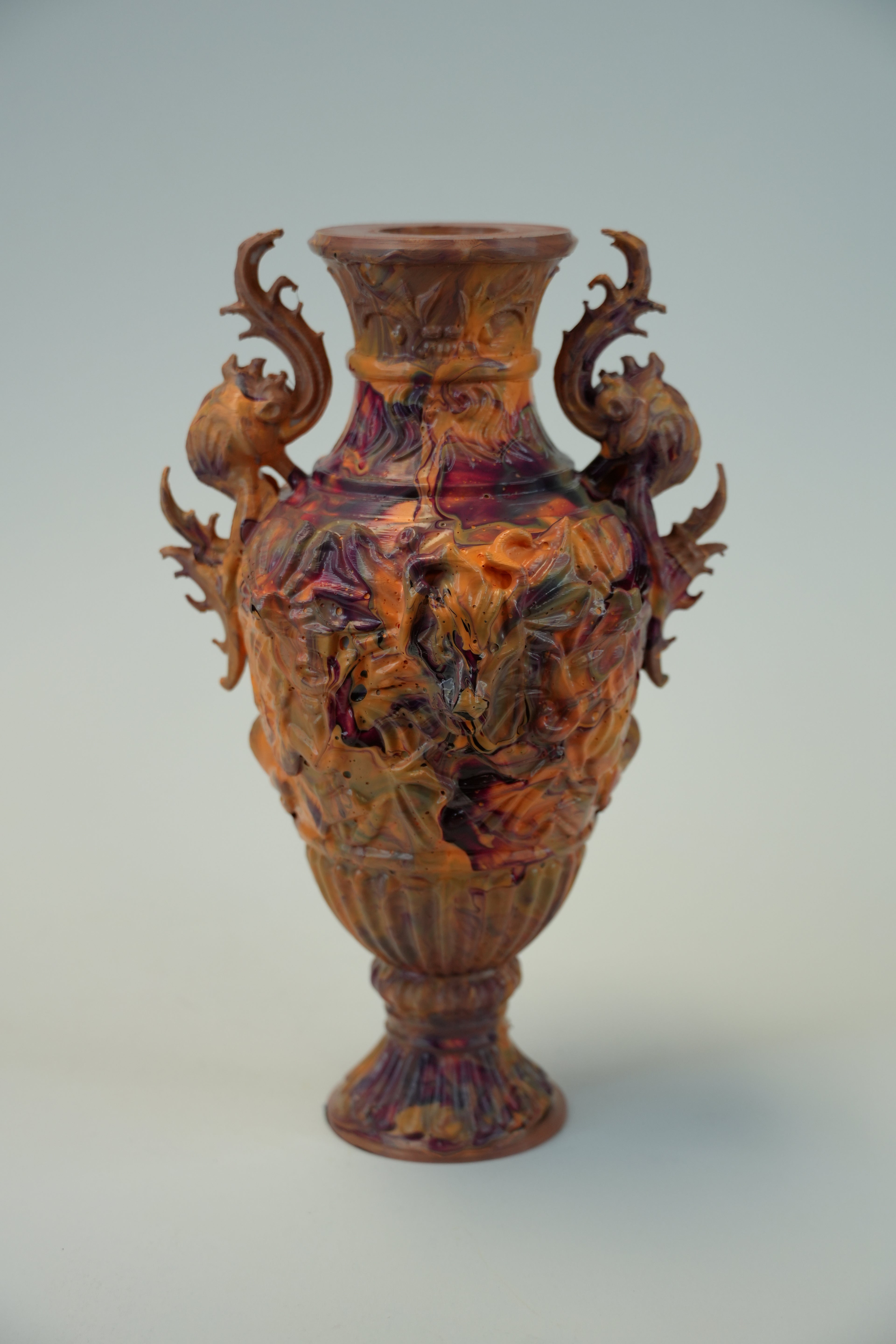 An ornate carved wooden vase with intricate dragon-like handles and a flared rim, shown against a plain light gray background.