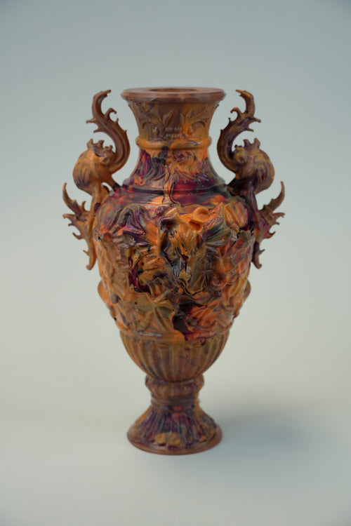 An ornate carved wooden vase with intricate dragon-like handles and a flared rim, shown against a plain light gray background.