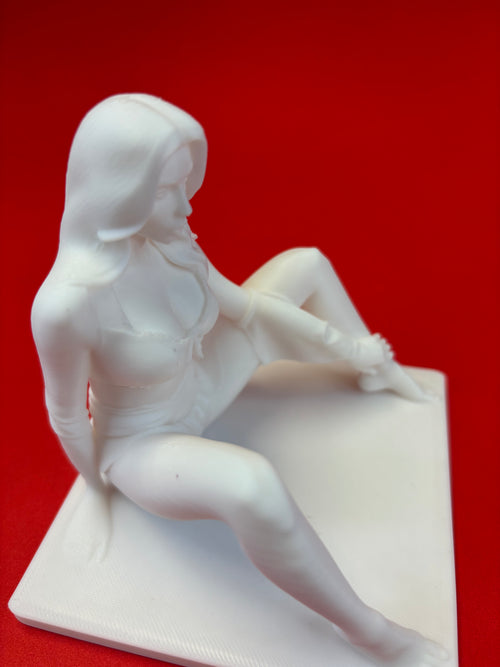 White sculpture of a seated figure on a red background