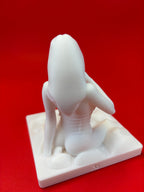 White sculpture of a dog on a red background