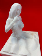 White sculpture of a figure on a red background