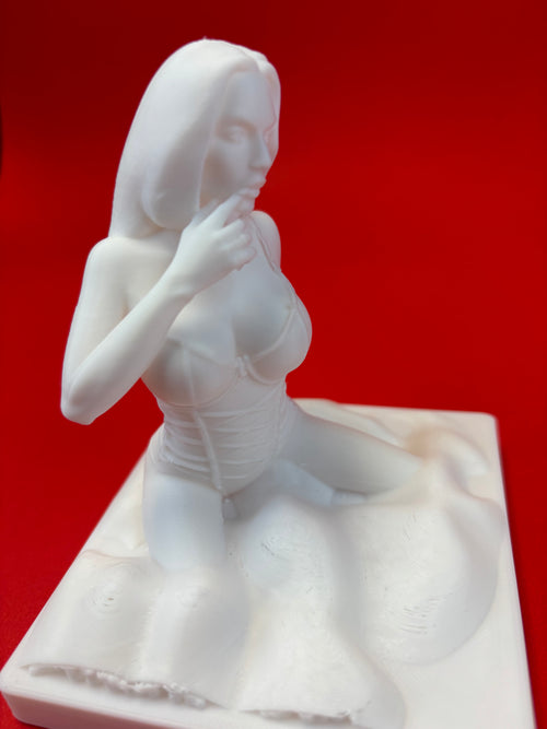White sculpture of a figure on a red background