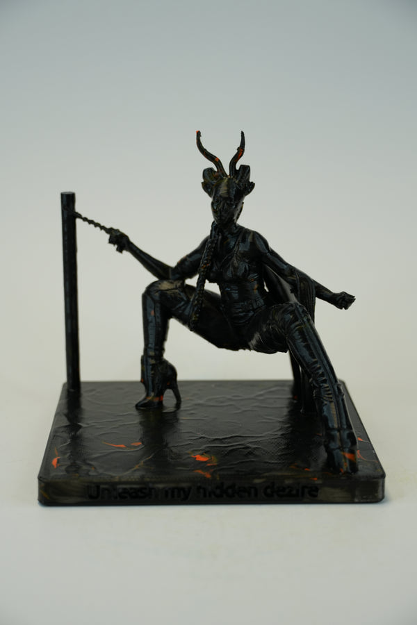 A dark, gothic figurine of a horned demon or devil seated on a base, holding a whip, photographed against a neutral light gray background.