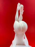 White sculpture of a figure in a headstand against a red background