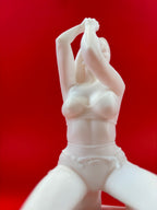 White ceramic figurine of a woman against a red background
