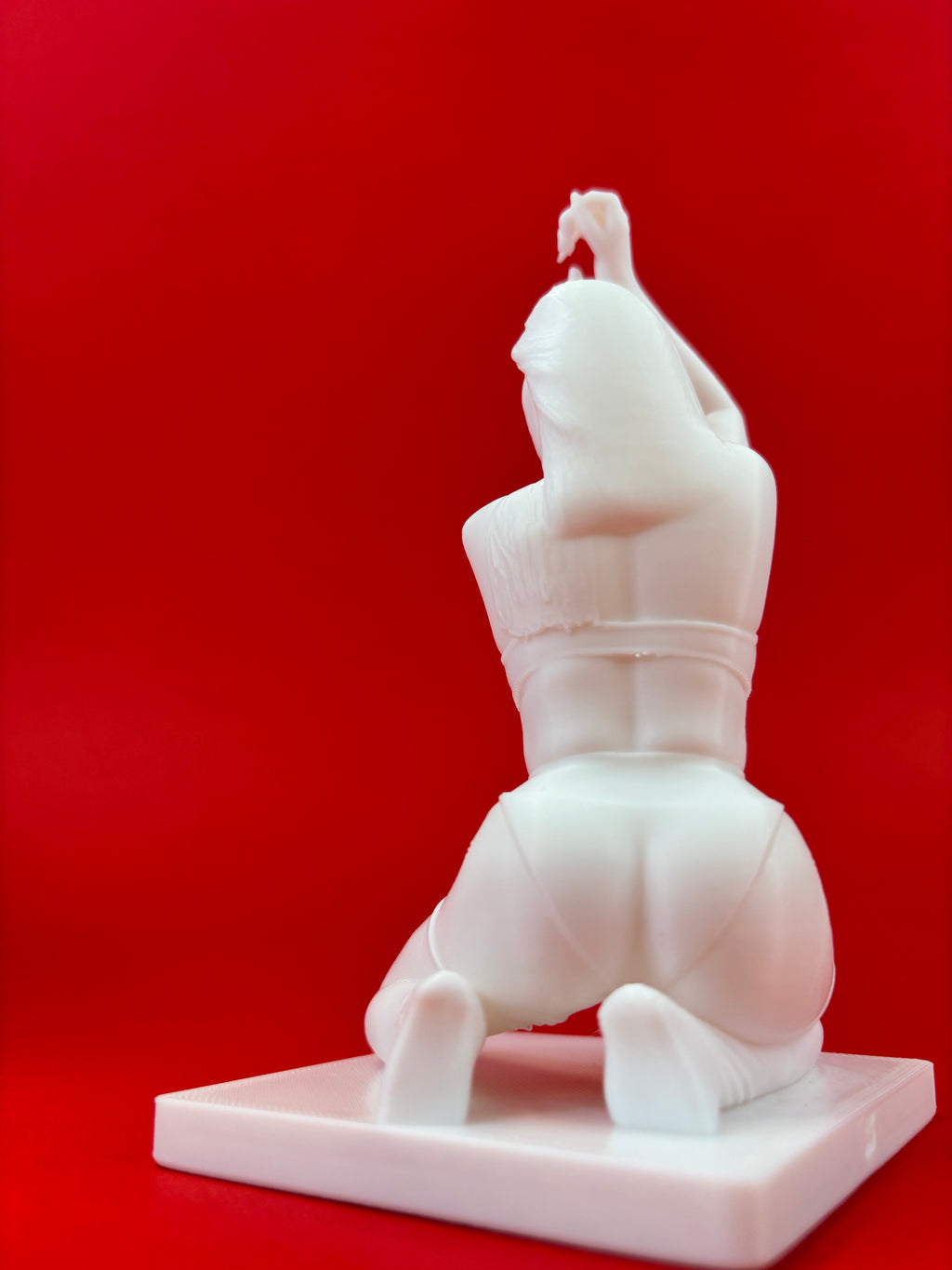 White sculpture on a red background