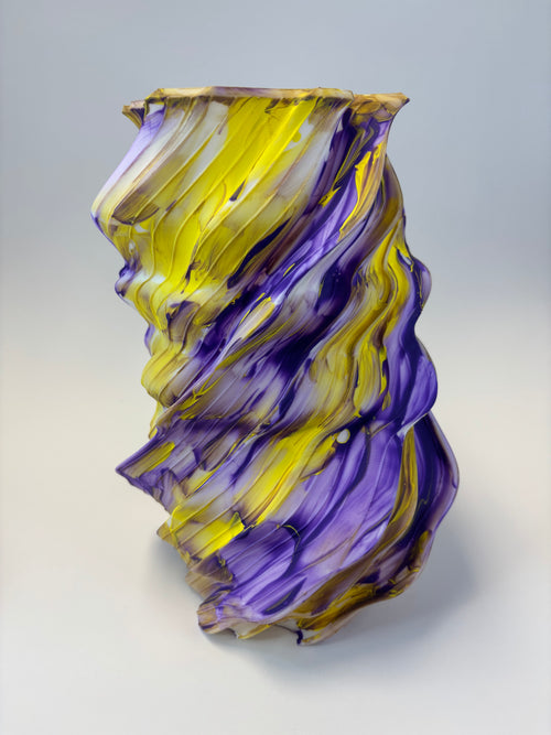 Abstract vase with purple and yellow swirl pattern..