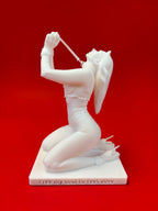 White sculpture of a reclining figure on a red background