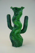 A sculptural green cactus-shaped vase with a glossy, marbled texture, photographed against a neutral light gray background.