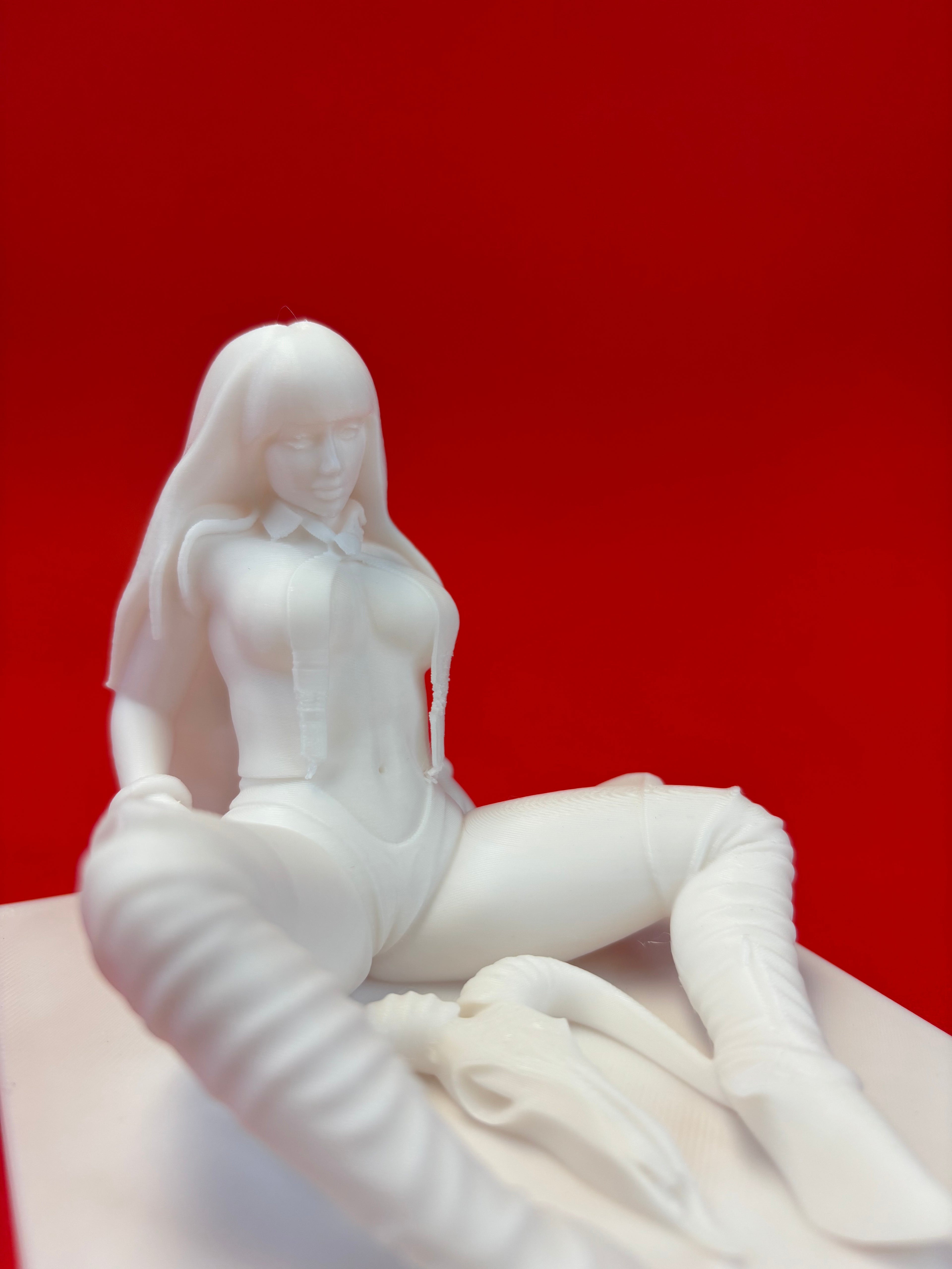 Close-up of a white sculpture against a red background
