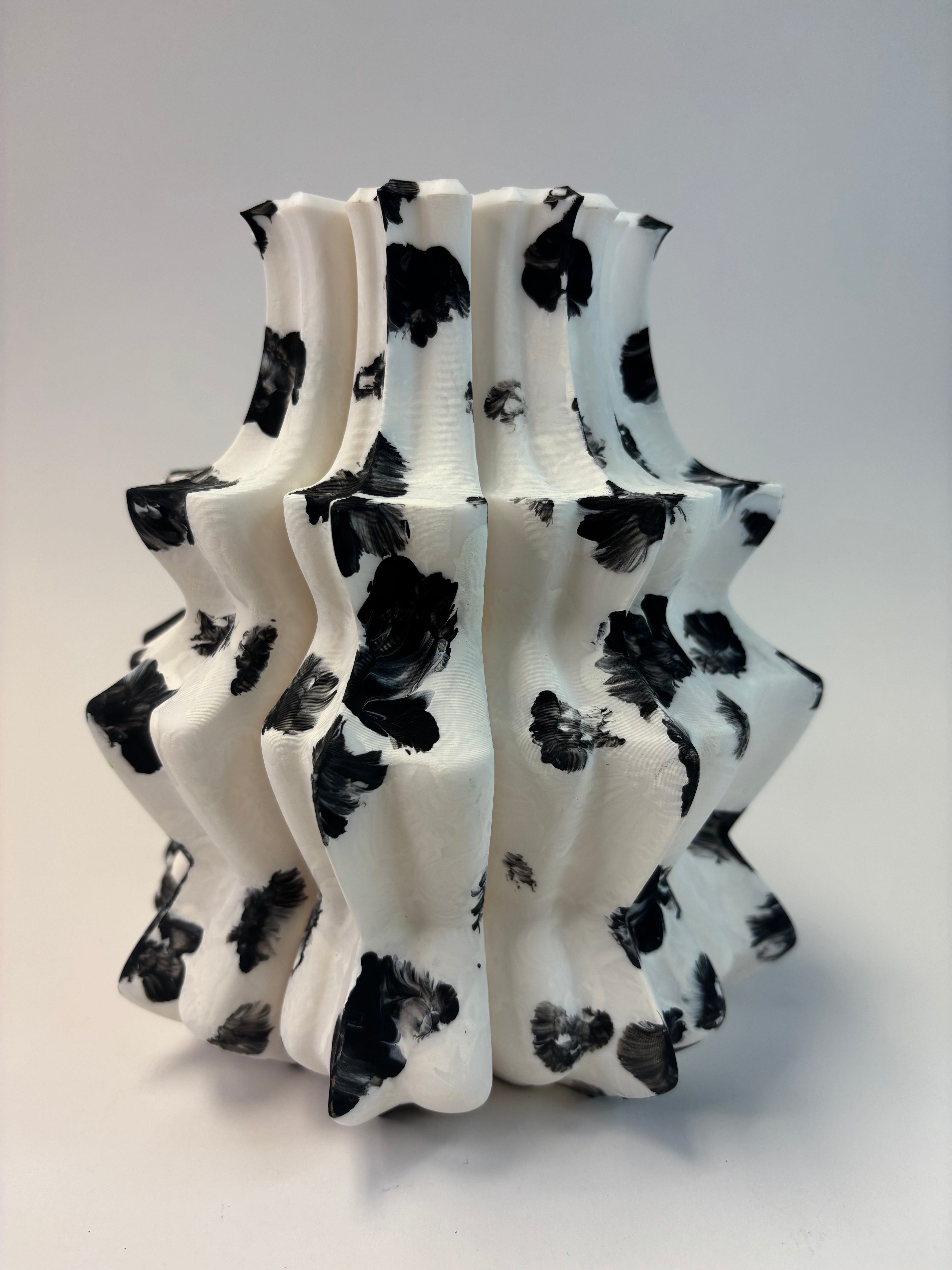 Decorative vase with black and white pattern on a light gray background