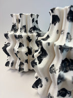 Black and white patterned vase on a light gray background