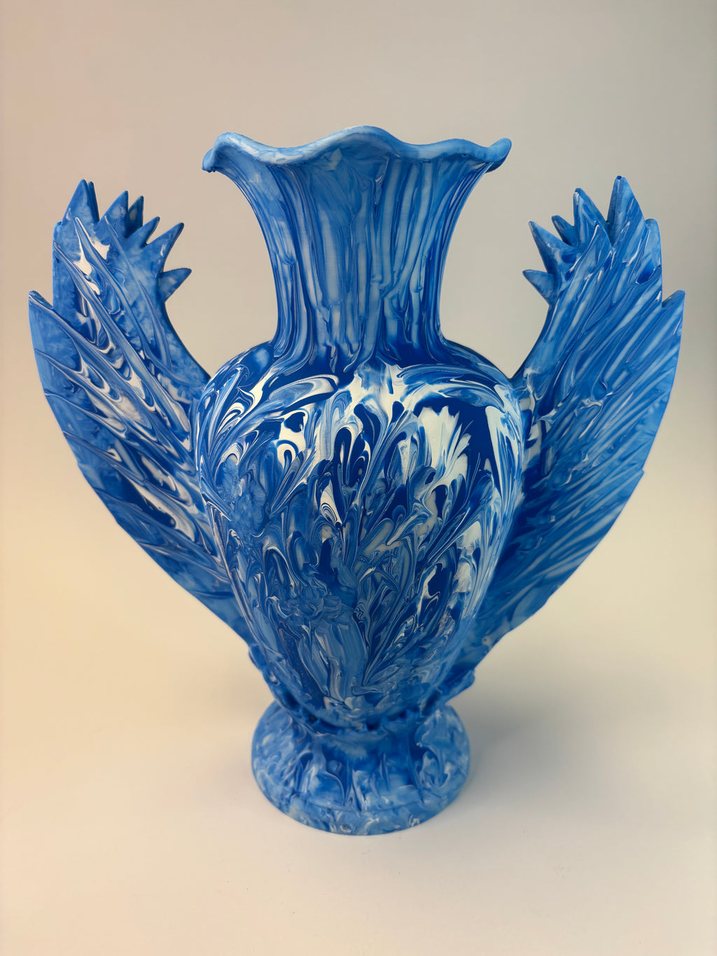 Blue vase sculpture on a beige background
