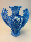 Blue vase sculpture on a beige background