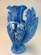 Blue vase with intricate patterns on a beige background