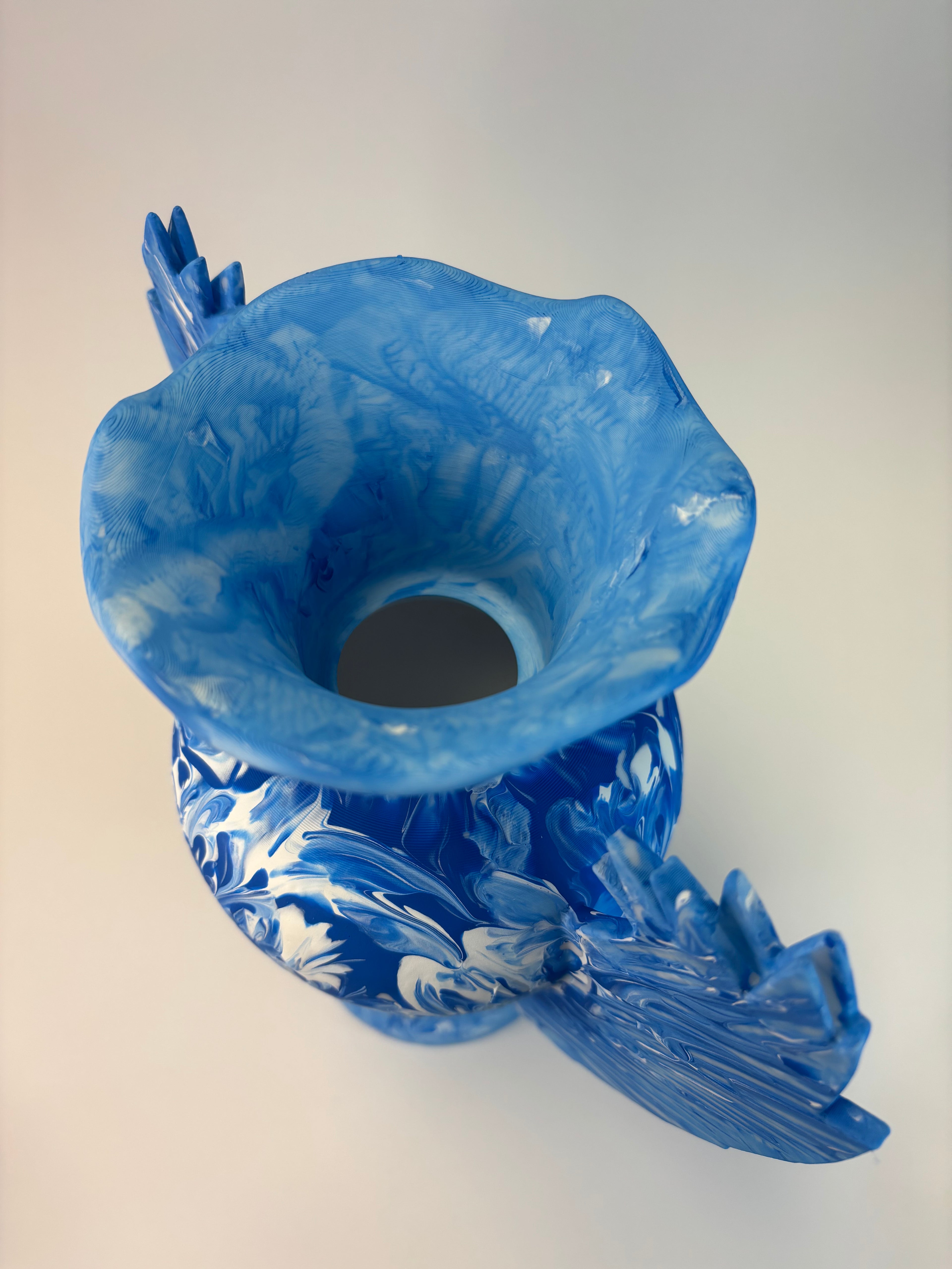 Blue vase with white marbled pattern on a white background