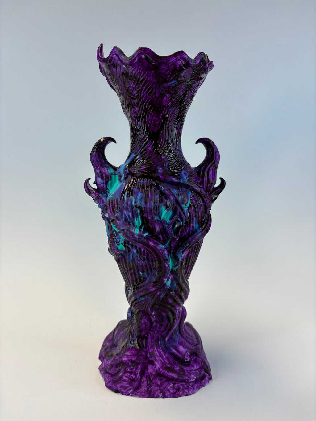 Decorative purple and black vase on a gradient background