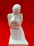 White statue of a woman on a red background