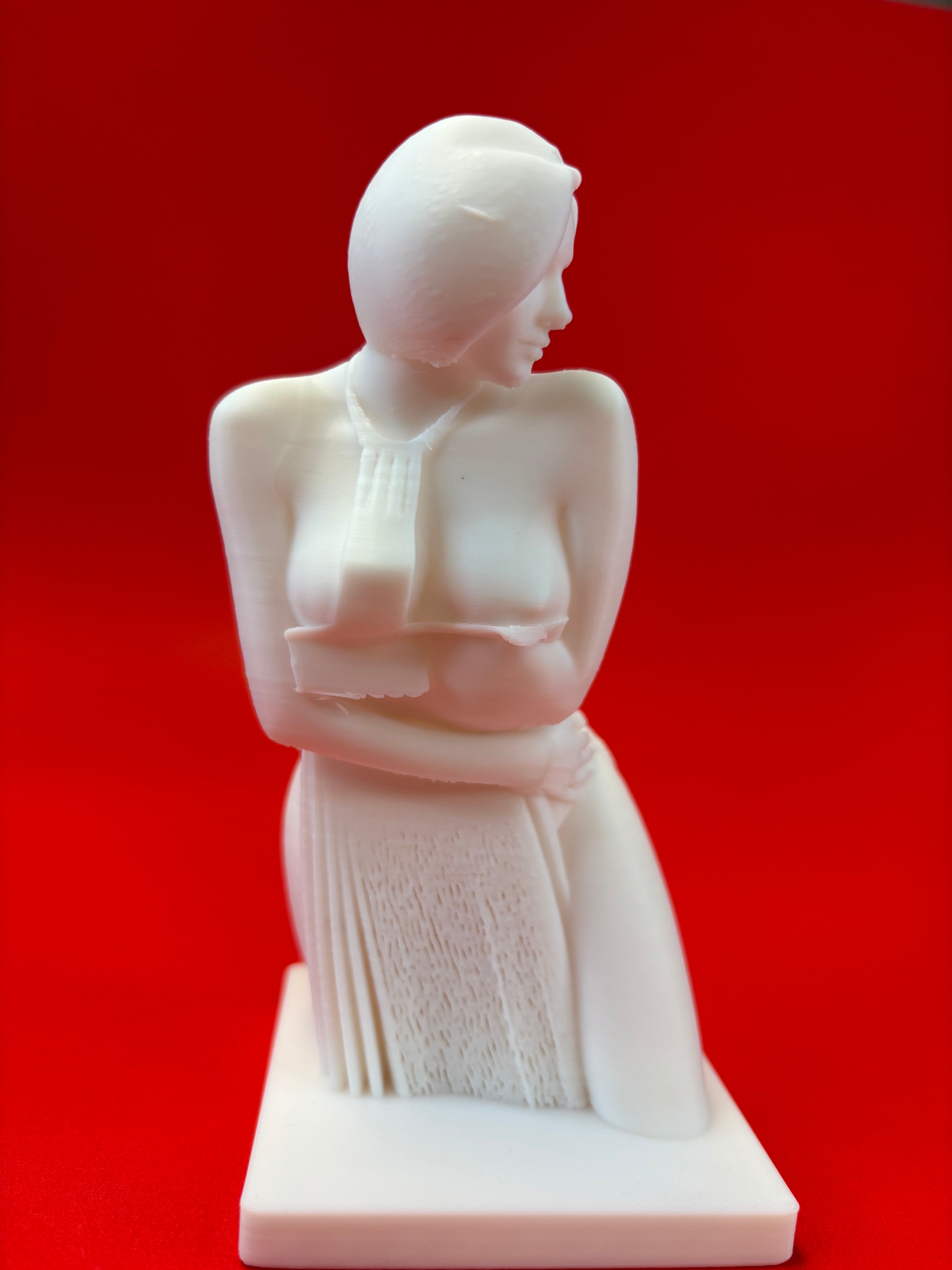 White statue of a woman on a red background