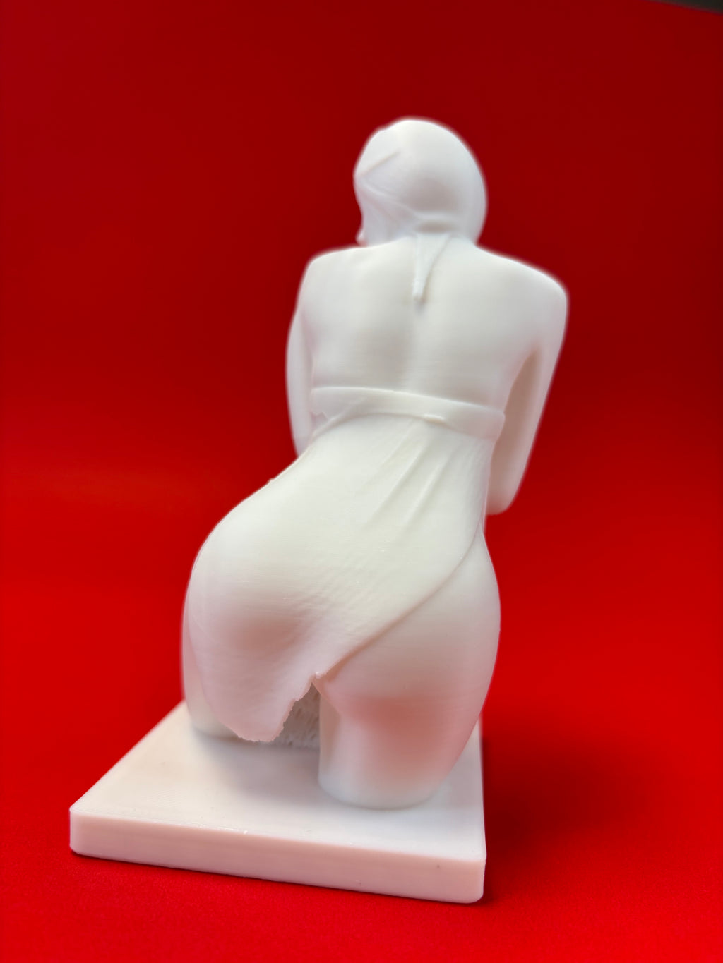 White marble statue on a red background
