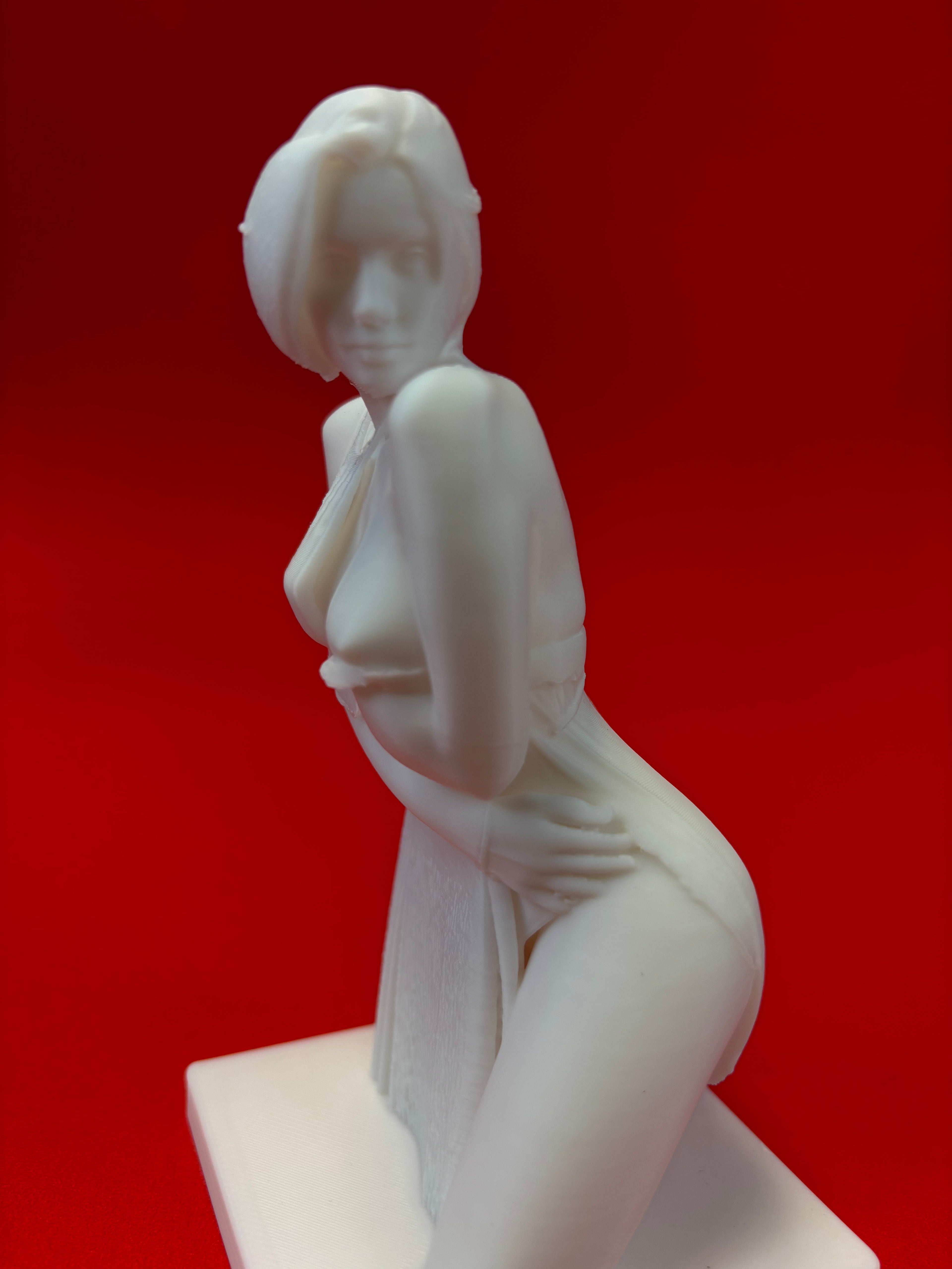 White statue of a person on a red background