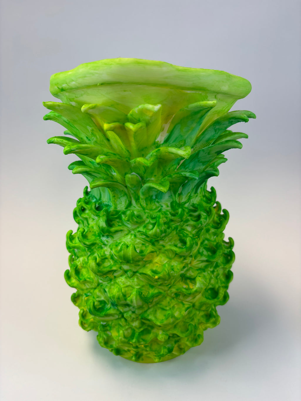 Green and earthy pineapple-shaped vase.