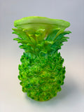 Green and earthy pineapple-shaped vase.