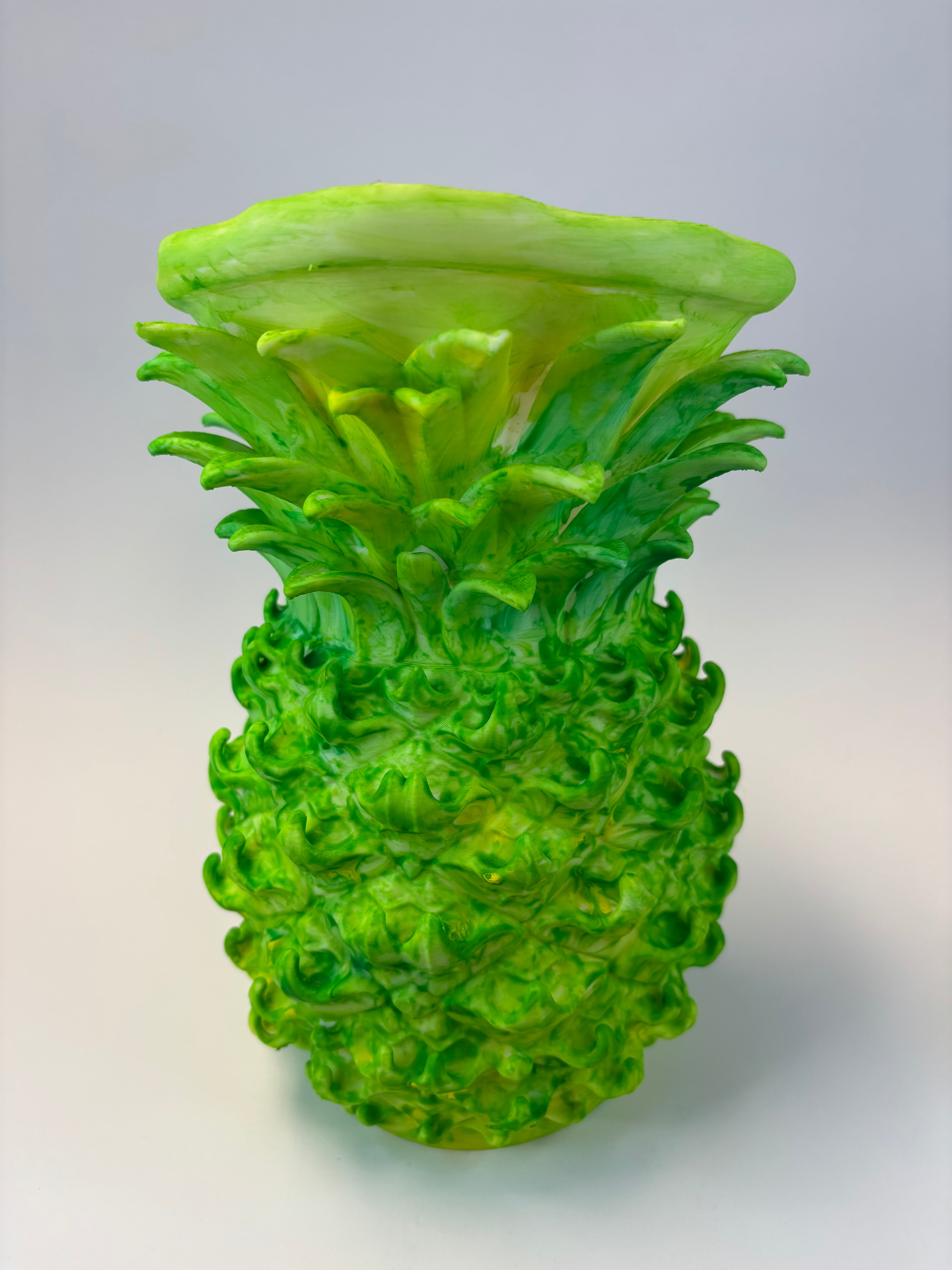 Green and earthy pineapple-shaped vase.