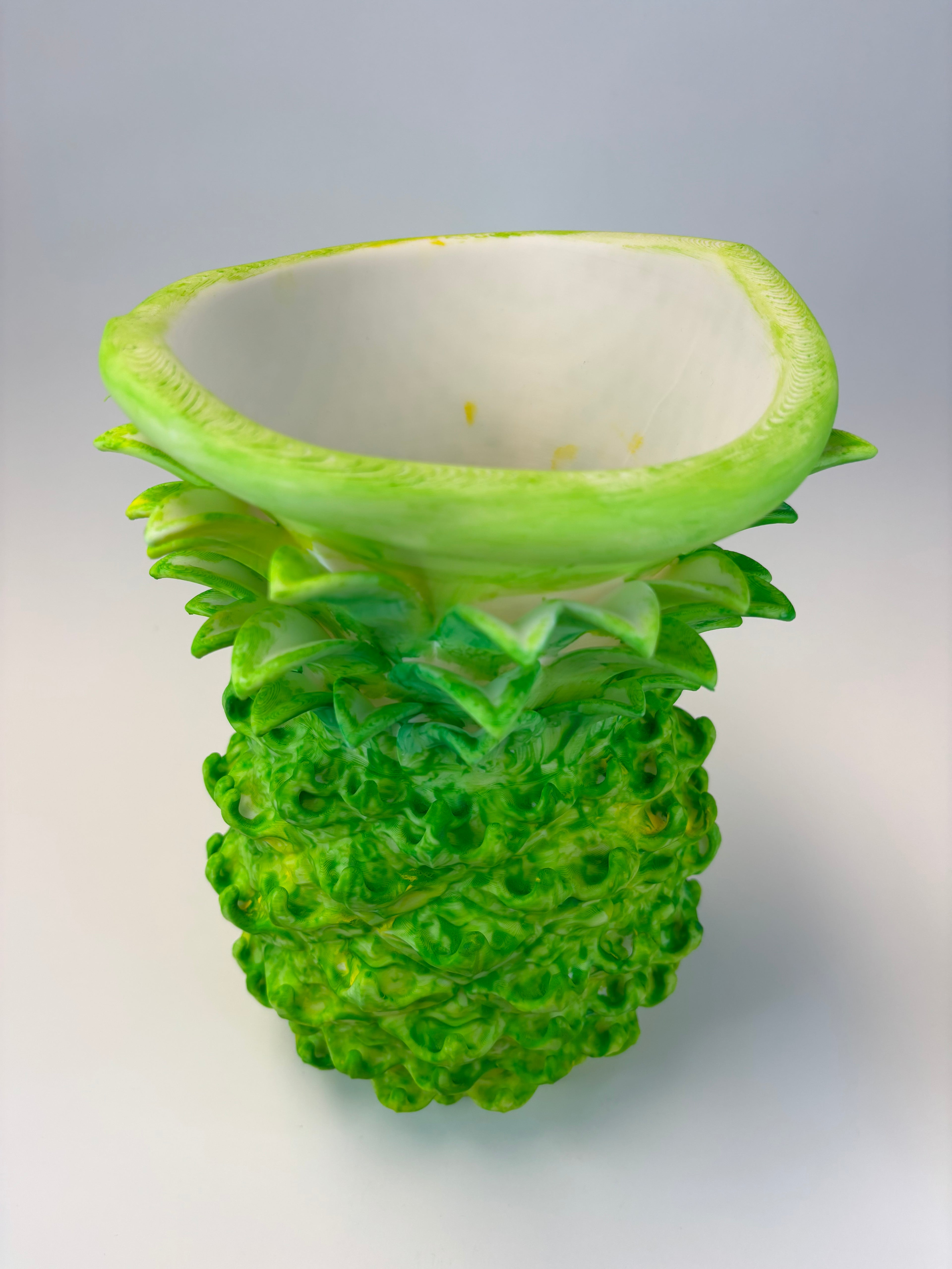 Green and earthy pineapple-shaped vase.