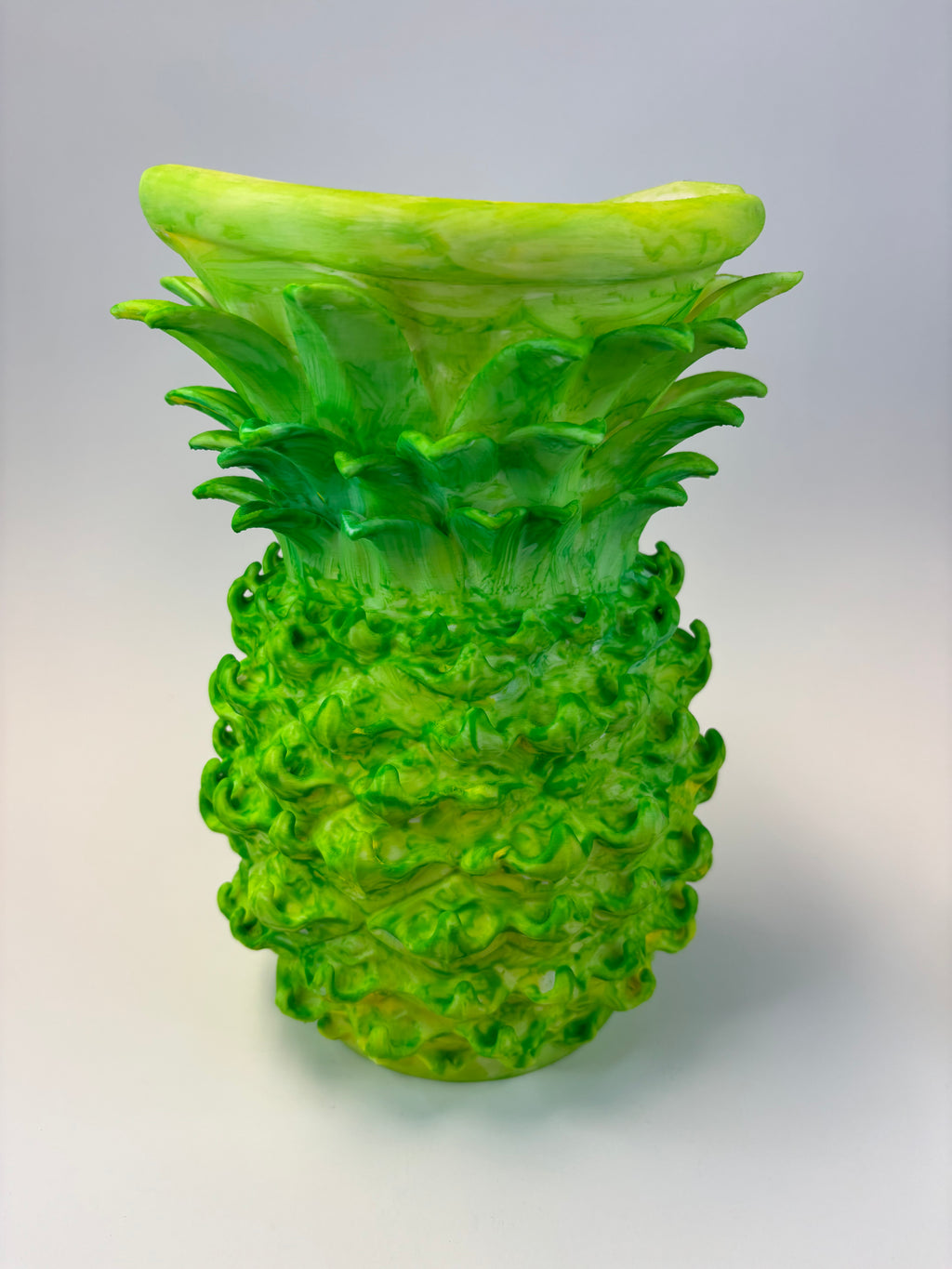 Green and earthy pineapple-shaped vase.