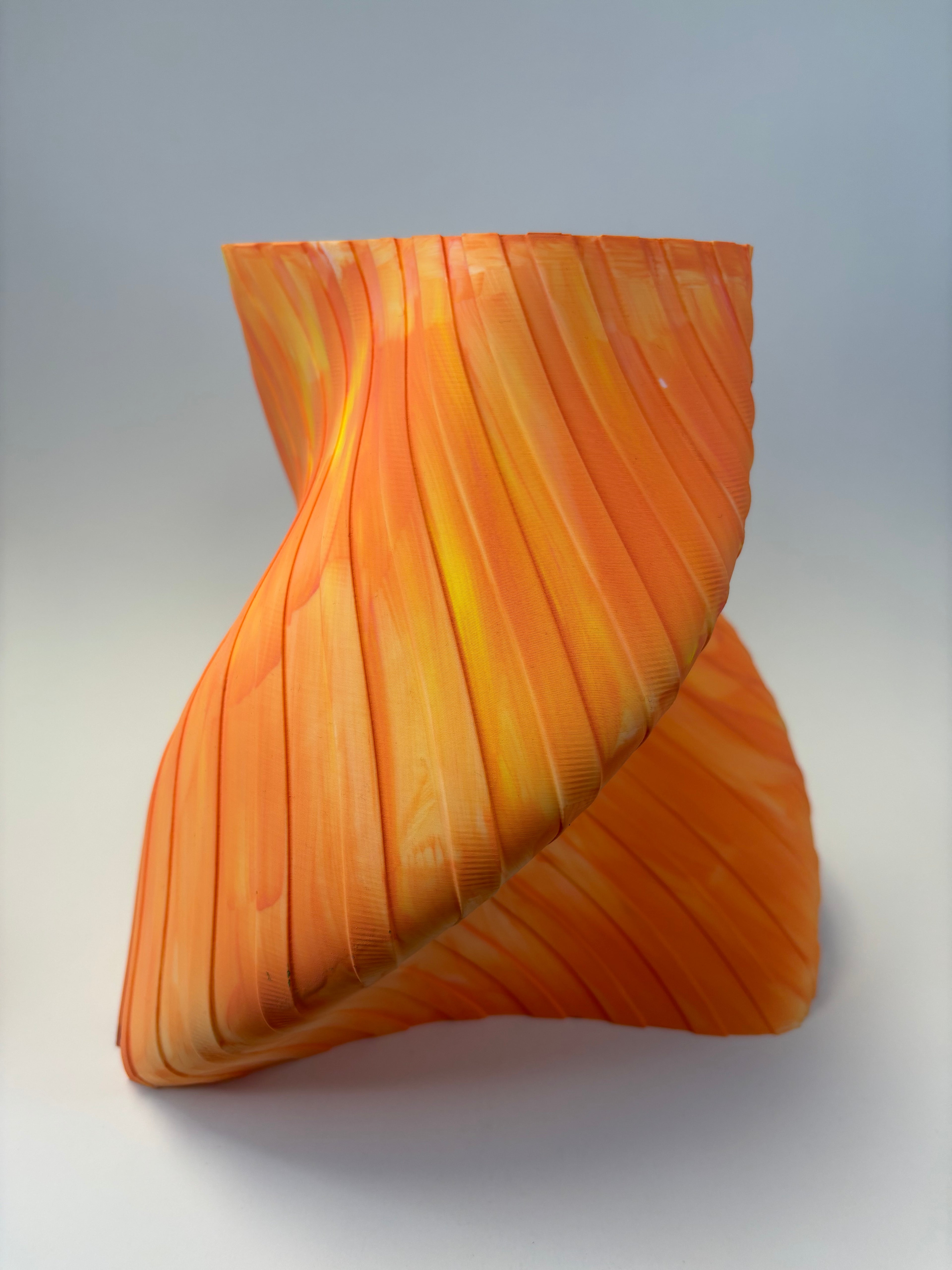 Orange decorative vase with wavy pattern and stripes.