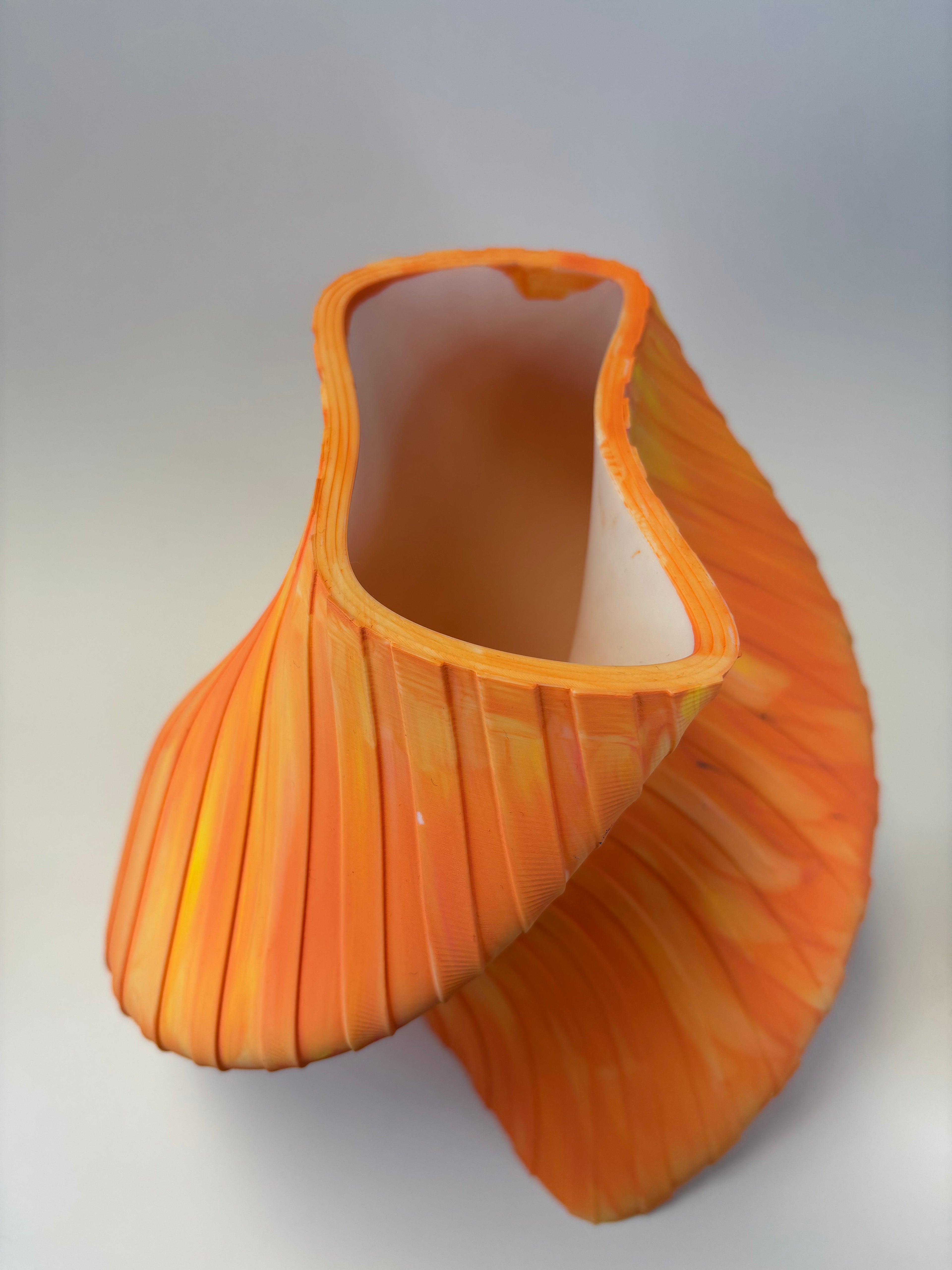 Orange decorative vase with wavy pattern and stripes.