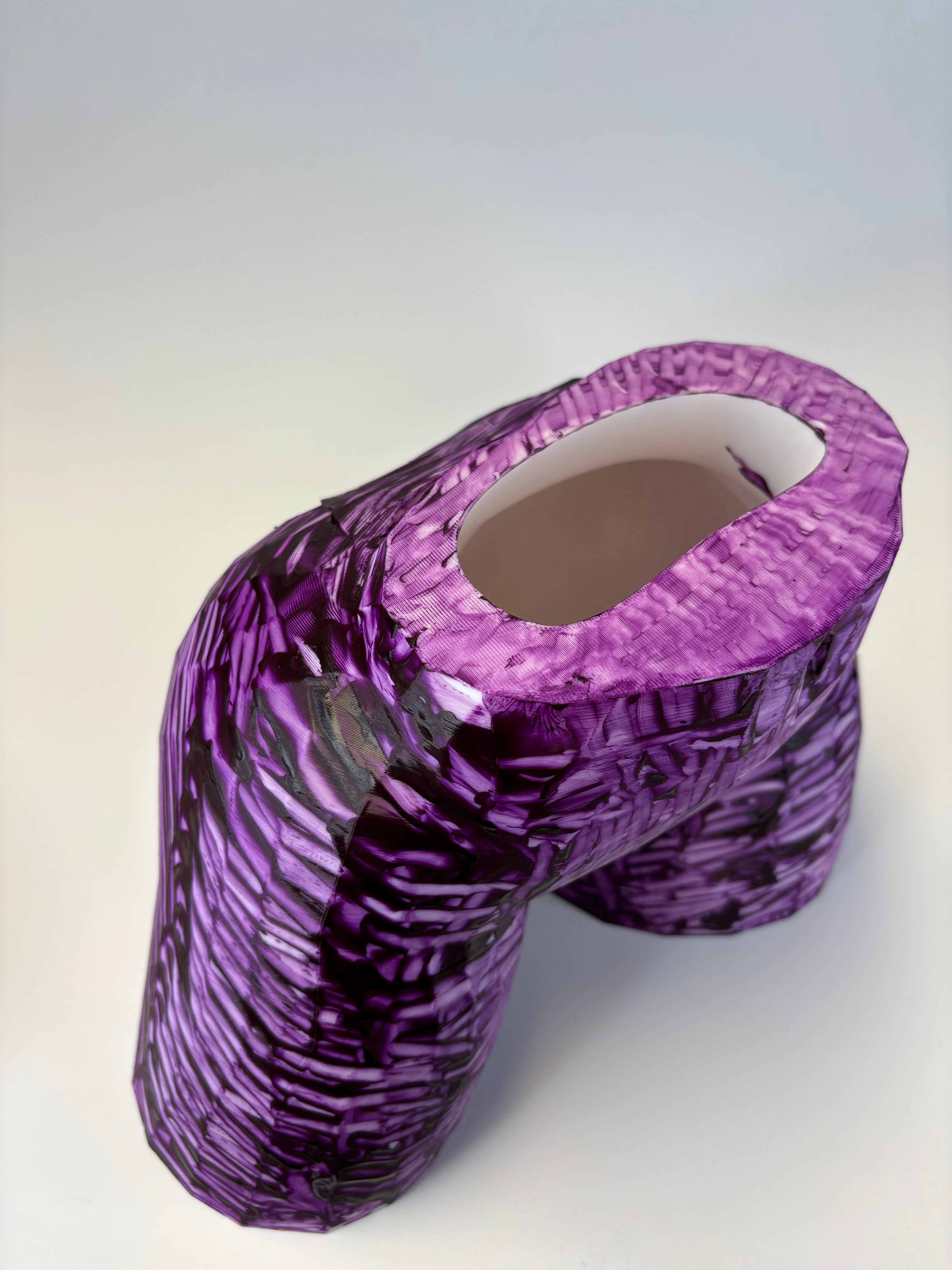 Purple and black patterned ass like vase.