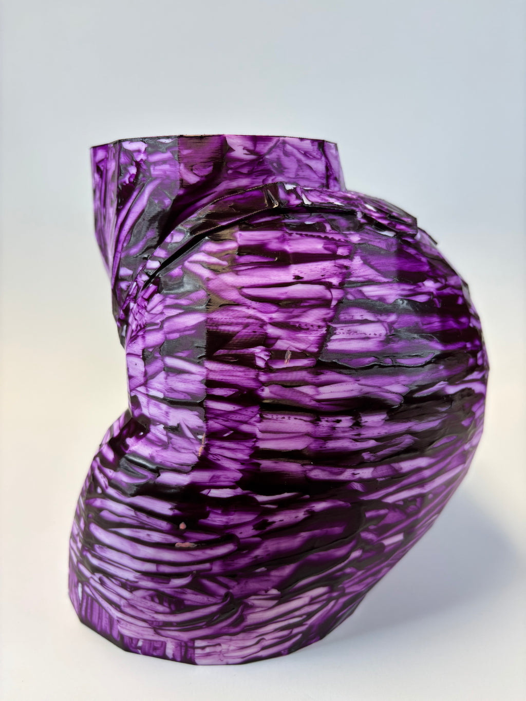 Purple and black patterned ass like vase.