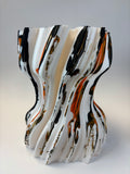 Abstract vase with wavy lines in black, white, and orange.