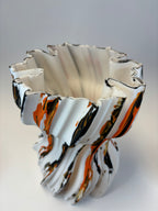 Abstract vase with wavy lines in black, white, and orange.