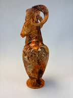 Decorative ram figurine vase on a plain background