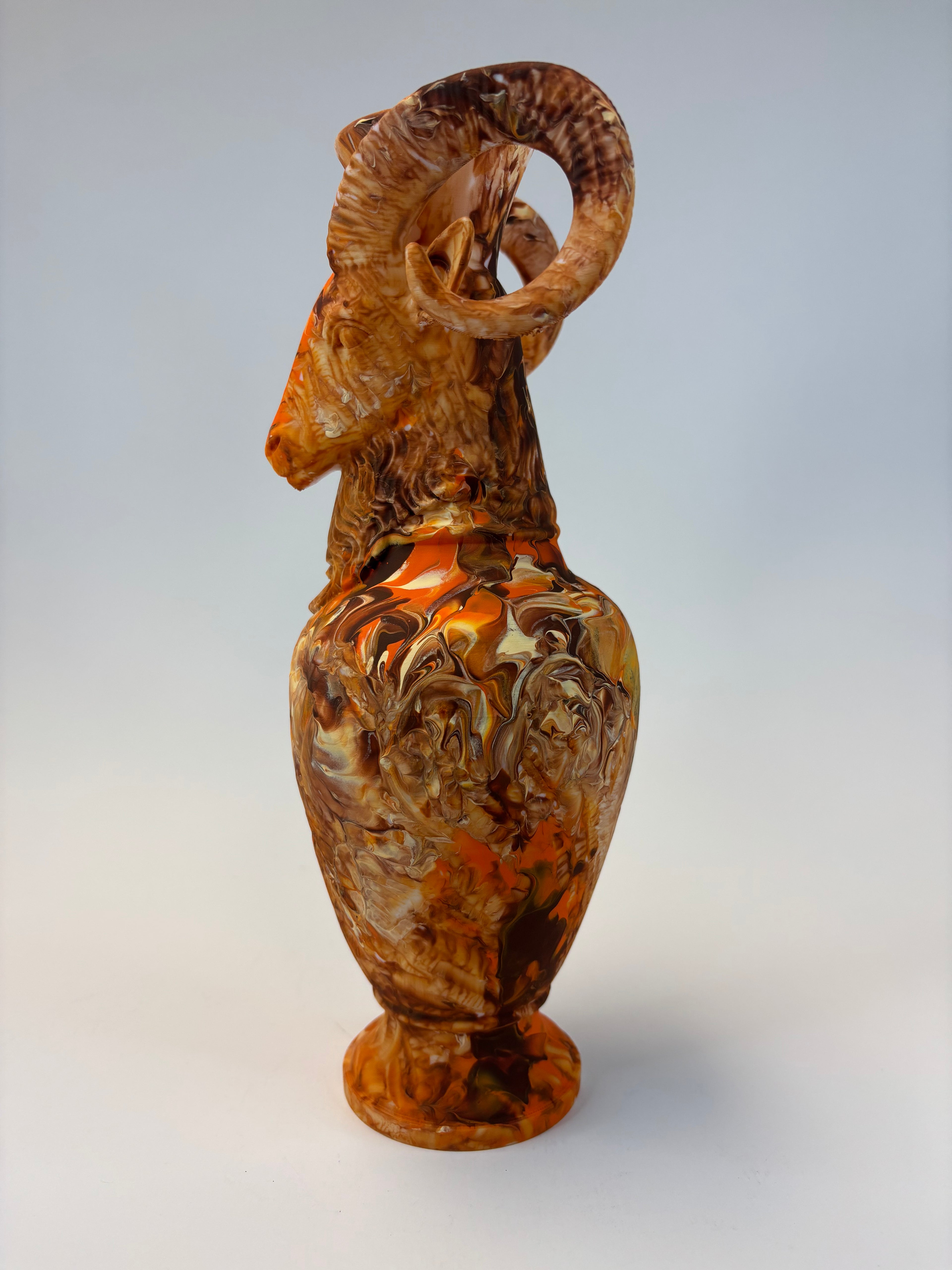 Decorative ram figurine vase on a plain background