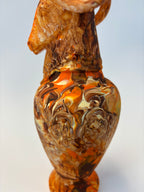 Marbled orange and brown vase on a white background