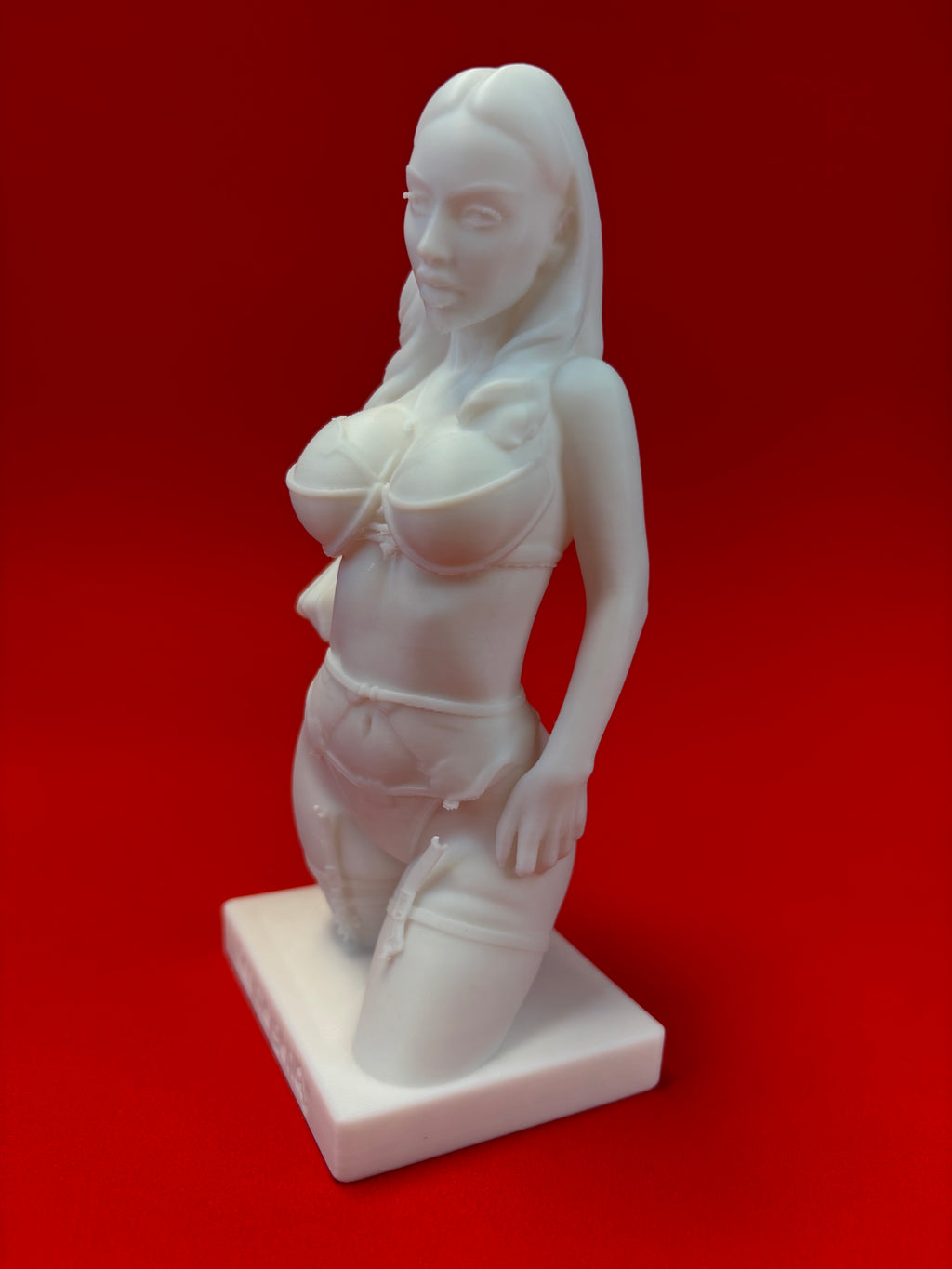 White statue of a woman on a red background