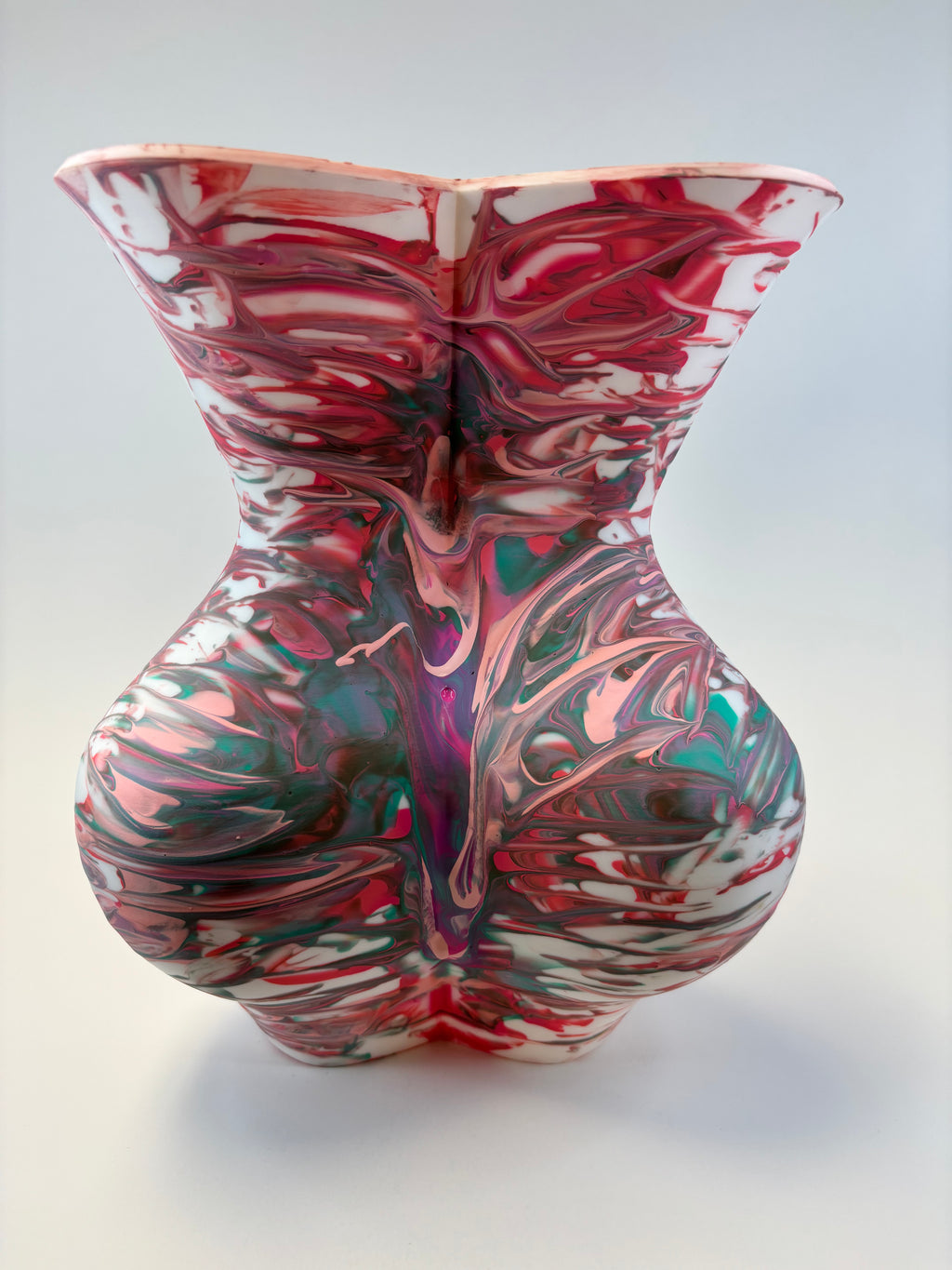 Marbled ceramic vase with multicolor design on a white background