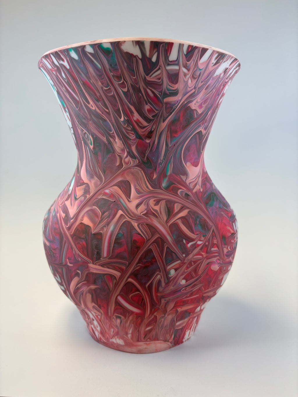 Marbled pink and purple vase on a white background