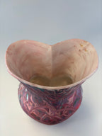 Vase with textured surface and colorful pattern on a white background