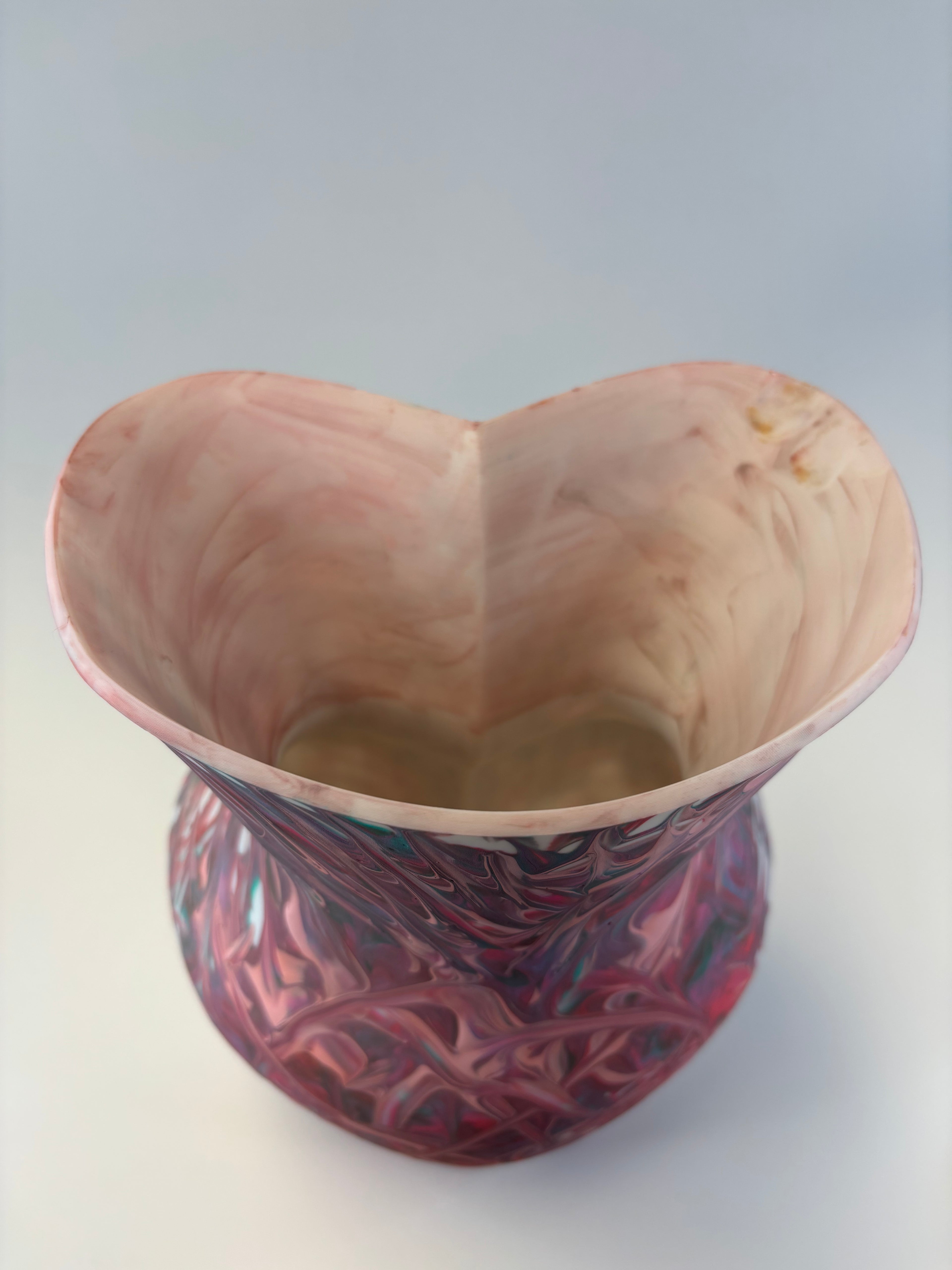 Vase with textured surface and colorful pattern on a white background