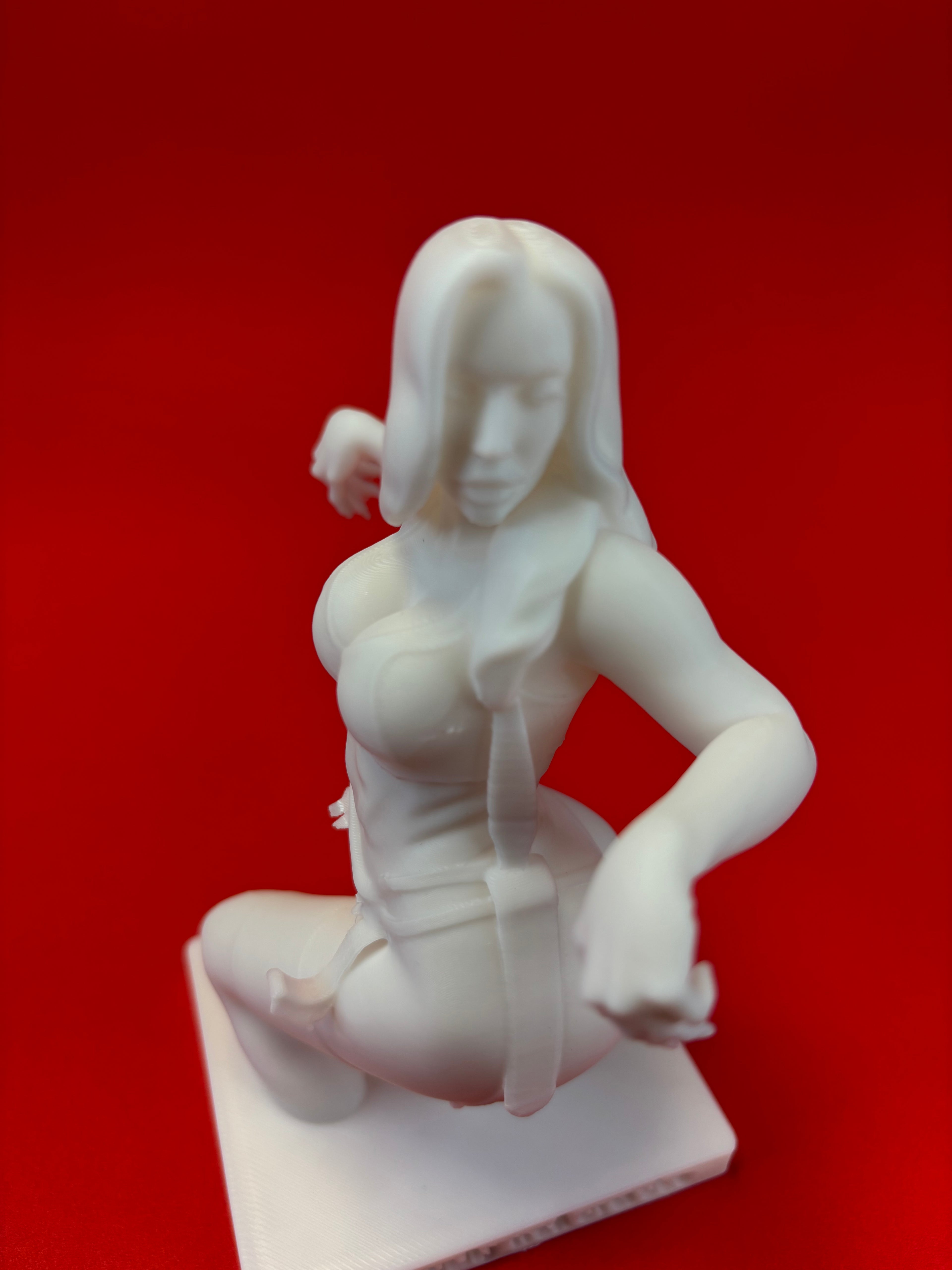 White sculpture of a person on a red background