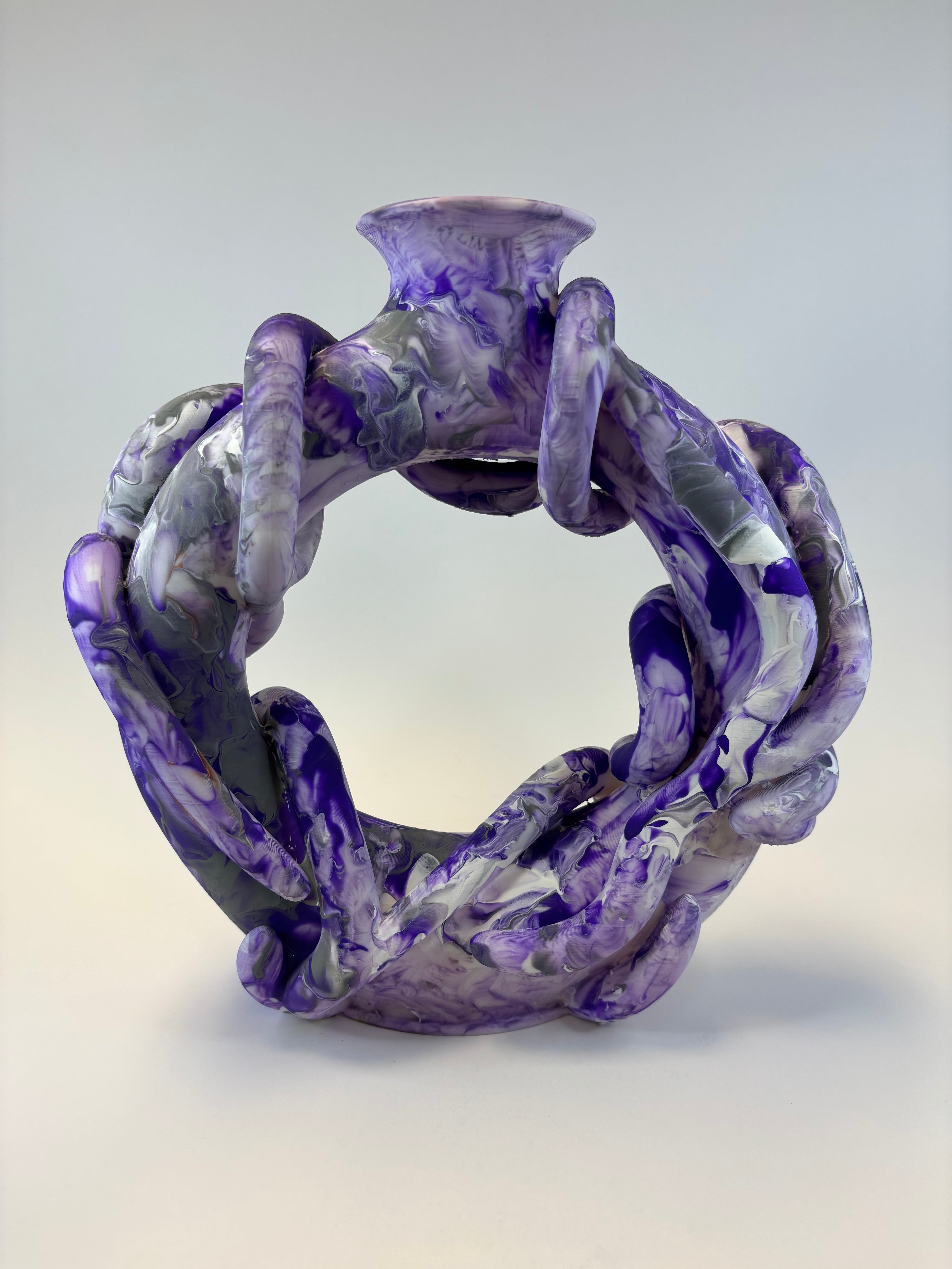 Purple and gray marbled ring vase on a light gray background