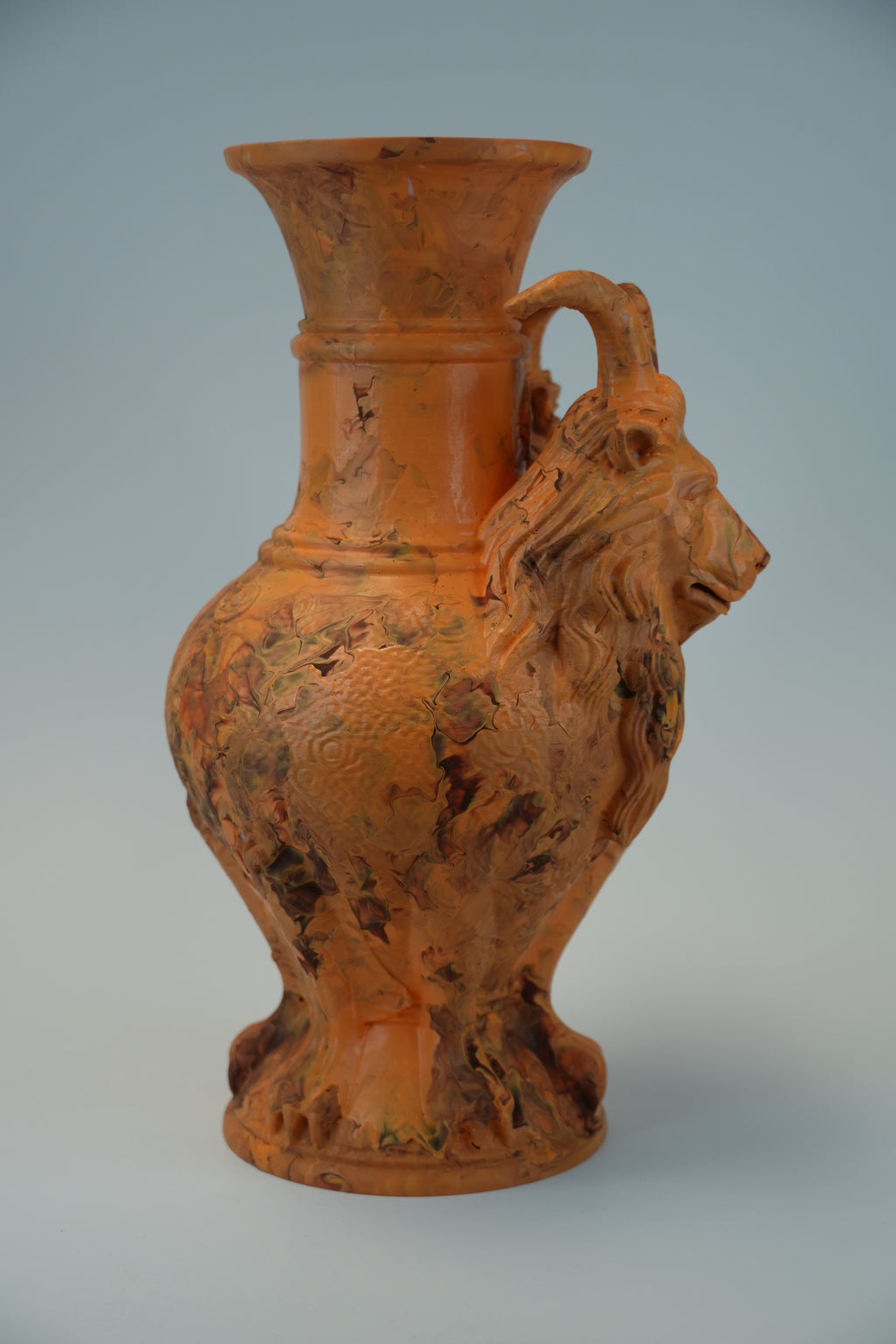An antique-style terracotta vase with a lion head handle and a textured, weathered finish, set against a solid light gray background.