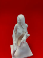 White sculpture of a figure on a red background